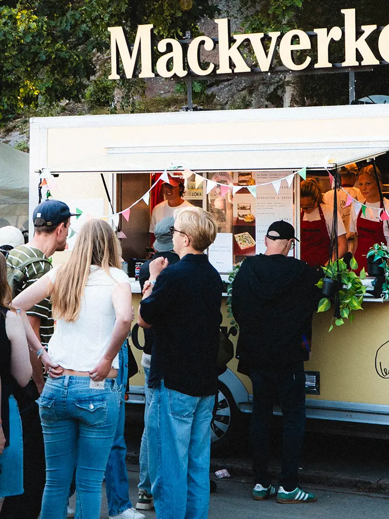 Kö av människor på en av mackverkets food truck